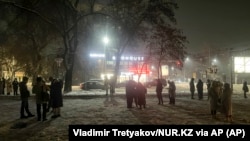 People gather in the street after fleeing apartment buildings foll;owing the earthquake in Almaty, Kazakhstan, late on January 22.