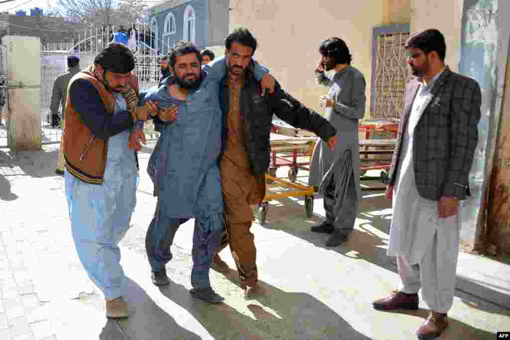 A bomb blast victim is helped to the hospital. The first attack happened in Pishin, a district in Balochistan Province near the Afghan border, local security official Naseebullah Kakar told RFE/RL's Radio Mashaal.