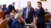 Георги Георгиев (с очилата) и Мирослав Боршош от групата на ГЕРБ в Столичния общински съвет (СОС) се смеят заедно с Вили Лилков (в средата) от "Синя София" по време на заседанието на съвета в четвъртък, 8 февруари 2024 г.
