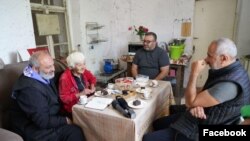 Armenia - Archbishop Bagrat Galstanian (left) meets a woman in Shurnukh village, June 30, 2024.