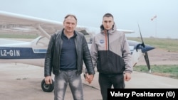 Bulgaria -- Father and Son portraits of men holding hands by Valery Poshtarov