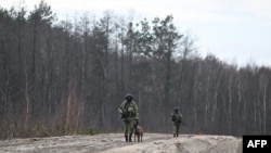 Belarusian border guards patrol along the frontier near the Divin border crossing point between Belarus and Ukraine in the Brest region on February 15, 2023.