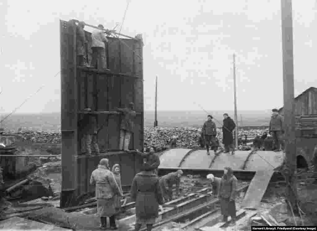 Această imagine are numele „Donbas își vindecă rănile” și arată muncitori reparând echipamente la mina de cărbune Dzerzinsky. Donbas a fost ocupat, între 1941 și 1943, de forțele armate naziste și italiene. Cele mai multe fotografii din colecție au fost făcute între 1944 și 1949. 