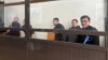 The activists appear in court in Almaty in February.