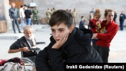 ARMENIA- A refugee boy from Nagorno-Karabakh waits upon his arrival at a temporary accommodation center in Goris, September 25, 2023. 