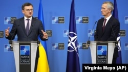 Ukrainian Foreign Minister Dmytro Kuleba (left, speaking to the press with NATO Secretary-General Jens Stoltenberg at NATO headquarters in Brussels in February) said decisions made at the summit had been "sharpened to accelerate our membership in NATO."