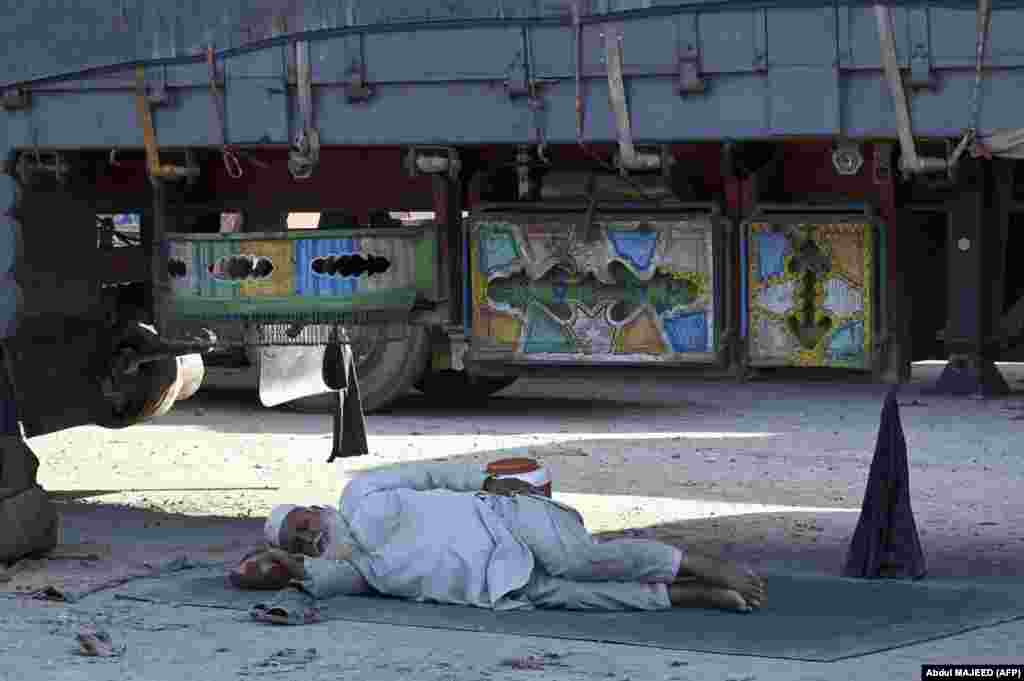 A man takes a nap under a truck near the Pakistani-Afghan border at Torkham on September 11. Hundreds of trucks and travelers were left stranded a week into the closure of the border, after a gunfight erupted across the frontier that left a Taliban guard and an Afghan civilian dead on September 6.