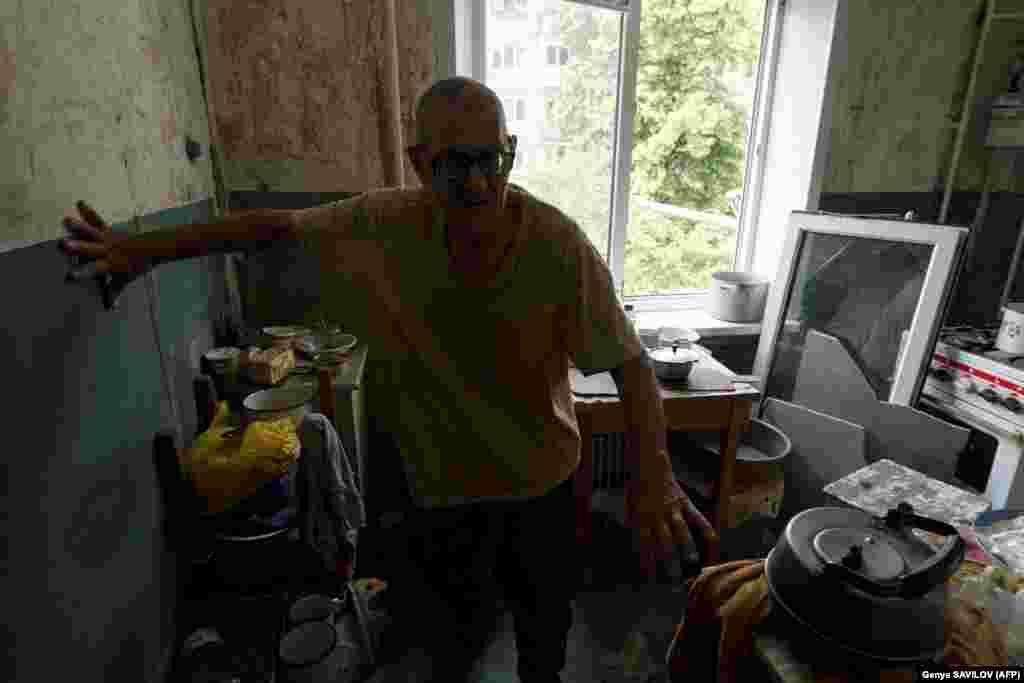 With no electricity or water, Grozdov relies on a camping stove and supplies provided by volunteer to survive. He refuses to leave his home and the town where his wife and son are buried.