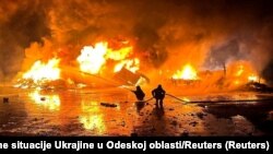 Firefighters work at a port compound on the Danube River damaged by a Russian drone strike in Ukraine's Odesa region in October.