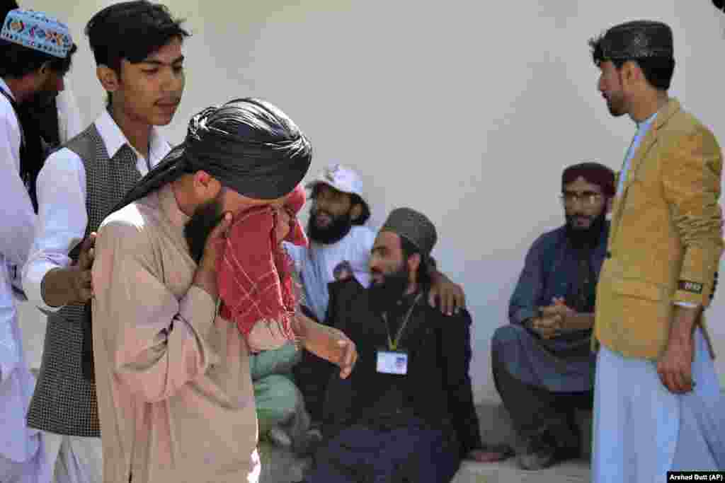 People mourn the deaths of their relatives and friends. The violence comes amid a recent surge in militant attacks, raising the stakes for security forces ahead of general elections in Pakistan, which have been scheduled for January.