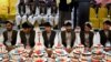 Afghan grooms attend a mass wedding ceremony at a hall in Kandahar, Afghanistan, on February 28.