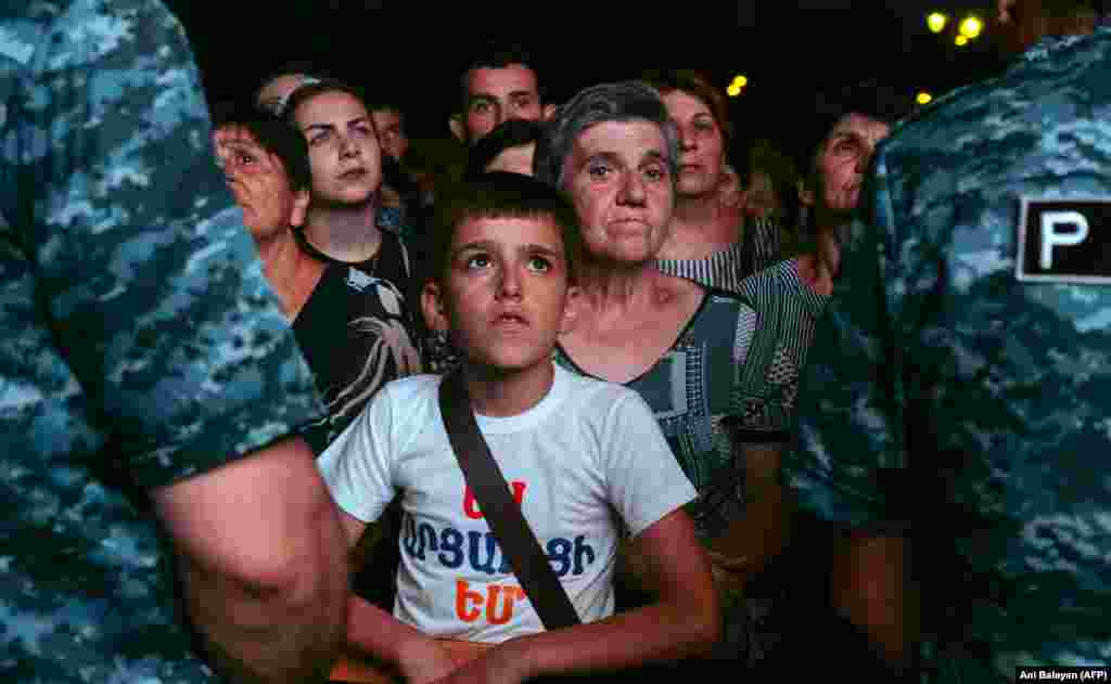Crowds inside blockaded Stepanakert, the largest city in Nagorno-Karabakh, watch a livestream of the Yerevan protest on July 25. Azerbaijan has called for the disbanding of the de facto government of Nagorno-Karabakh and claims Karabakh Armenians will have the same rights as other Azerbaijani citizens. But several brutal murders of ethnic Armenians blamed on Azerbaijani soldiers inside territory retaken during the war over Nagorno-Karabakh that broke out in 2020 has left some observers fearing the worst if control of the region is handed back to Baku.