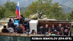 Ethnic Armenian flee Karabakh for Armenia sitting in a truck at the Lachin checkpoint controlled by Russian peackeepers and Azeri border guards, 26 September 2023.