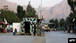 Taliban security personnel stand guard near the closed gates of the Torkham border crossing between Afghanistan and Pakistan in Afghanistan's eastern Nangarhar Province on September 6.