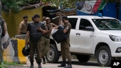 Police officers prepare to take position outside the residence of former Prime Minister Imran Khan,in Lahore, Pakistan, on August 5.