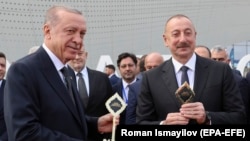 Turkish President Recep Tayyip Erdogan (left) and Azerbaijani President Ilham Aliyev attend an opening ceremony of the new international airport in Zangilan, Azerbaijan, on October 20, 2022.
