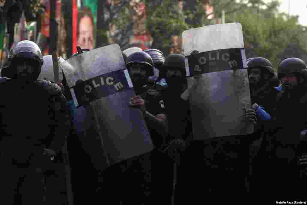 Video images released by PTI showed police striking Khan supporters with batons and lobbing tear-gas canisters, some of which landed on the lawn of Khan's house, while Khan's supporters hurled rocks and bricks at the officers.