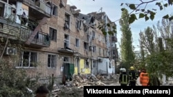 Rescuers work at the site of an apartment building damaged by a Russian military strike in Mykolayiv in southern Ukraine on October 13.