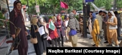 Afghan women protest the Taliban leader’s decree requiring them to cover their faces in public.