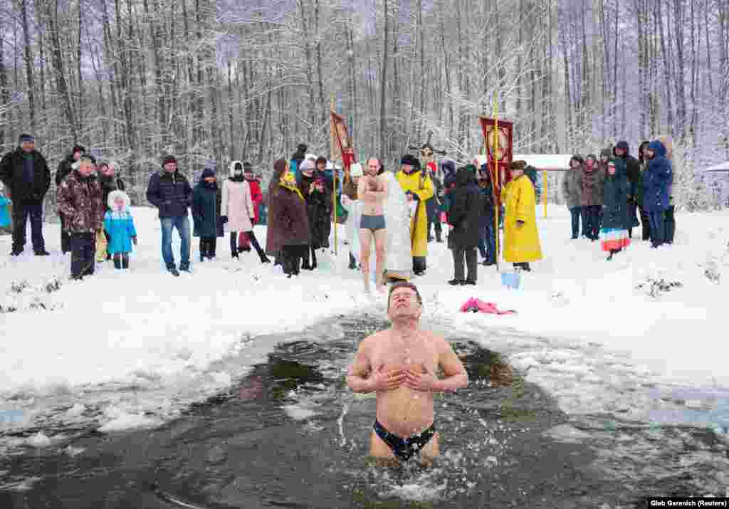 Мешканці Іванковичів пірнають у крижану воду під час Водохреща. Реформи в українській системі охорони здоров’я заплановані на 2020 рік.