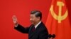 Chinese President Xi Jinping waves after introducing the members of the Chinese Communist Party's new Politburo Standing Committee, the country's top decision-making body, in the Great Hall of the People in Beijing on October 23.