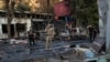 A Ukrainian military member walks past burned cars at a market following a Russian strike in Kostyantynivka, Ukraine's eastern Donetsk region on September 6, 2023, amid the Russian invasion of Ukraine.