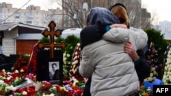 Mourners react by the grave of Russian opposition leader Aleksei Navalny at a Moscow cemetery on March 2.