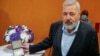 Nobel Peace Prize laureate Dmitry Muratov poses with his 23-carat medal before it is auctioned at the Times Center on June 20 in New York. 