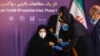 A woman receives an injection during the first trial phase of a locally made Iranian vaccine for COVID-19 in the capital, Tehran, on December 29.