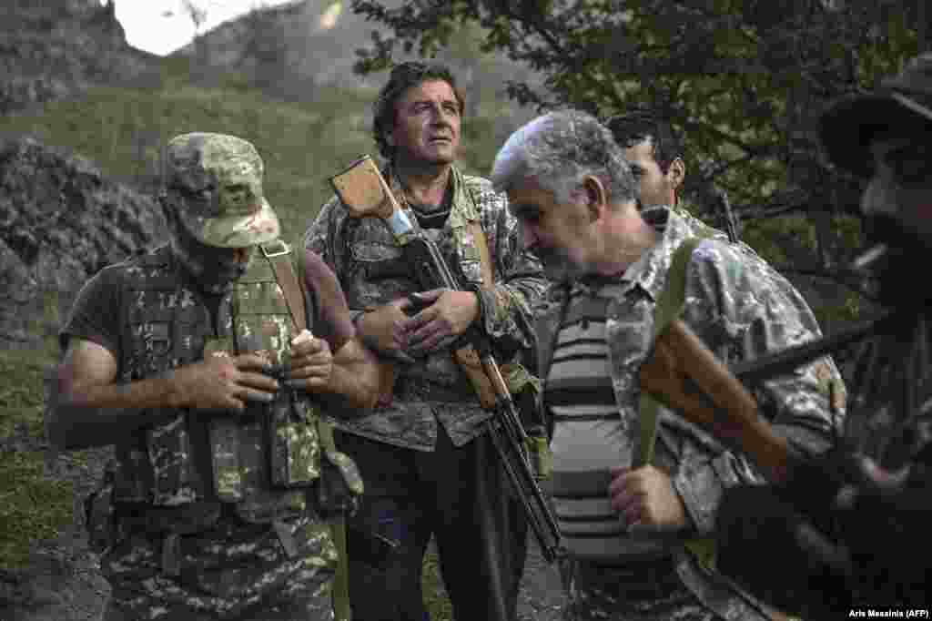 Ethnic Armenian men with Soviet-made weapons in a village in Nagorno-Karabakh -- a breakaway region which is internationally recognized as part of Azerbaijan -- on October 23. 