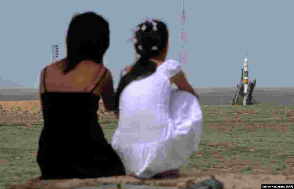 Kazakh girls watch as a Soyuz rocket prepares for launch in 2009. As work continues on Russia’s troubled Vostochny Cosmodrome and SpaceX aims to ferry astronauts to the ISS from U.S. soil beginning on May 27, Kazakhstan's aging launch facility and the population it supports is likely to be left behind. 