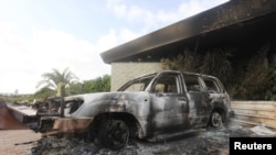 A burned-out car outside the destroyed U.S. Consulate in Benghazi