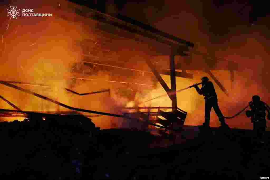 Ukrainian firefighters work at the site of a Russian drone strike in the Poltava region,