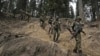 Indian soldiers trek back after a search operation in the day after an attack in Pahalgamthat killed 26 civilians.