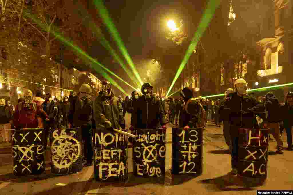 Protesters on Rustaveli Avenue armed with clubs and makeshift shields on December 4. 