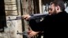Members of the Free Syrian Army shoot at a nearby government army position in the Al-Jadeida neighbourhood of Aleppo.