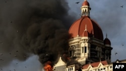 Flames gush out of The Taj Mahal Hotel in Mumbai during the 2008 siege.