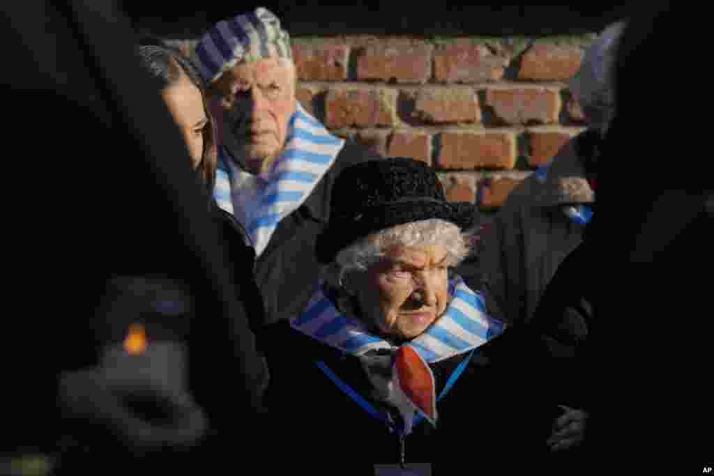 Supraviețuitorii și rude ale supraviețuitorilor participă la o ceremonie în fostul lagăr de concentrare și exterminare nazist german Auschwitz-Birkenau, în Oswiecim, Polonia, luni, 27 ianuarie 2025. 