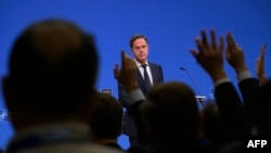 NATO Secretary-General Mark Rutte takes questions from reporters on December 3 in Brussels. 