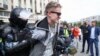 Police officers detain a participant in an unauthorized rally in support of rejected independent candidates in the upcoming Moscow City Duma [Moscow parliament] election held by Russian opposition in Pushkinskaya Square