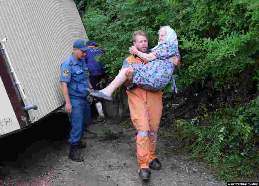 Un bărbat care participă la eforturile de salvare este văzut ducând o femeie în brațe în Kuibysheve. 