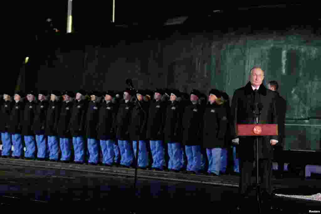 Russian President Vladimir Putin (right) attends a launching ceremony for a nuclear-powered submarine in Arkhangelsk.
