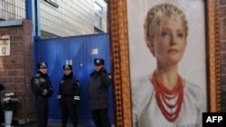 A supporter of Yulia Tymoshenko holds her portrait during rally in front of a prison in Kyiv last year.