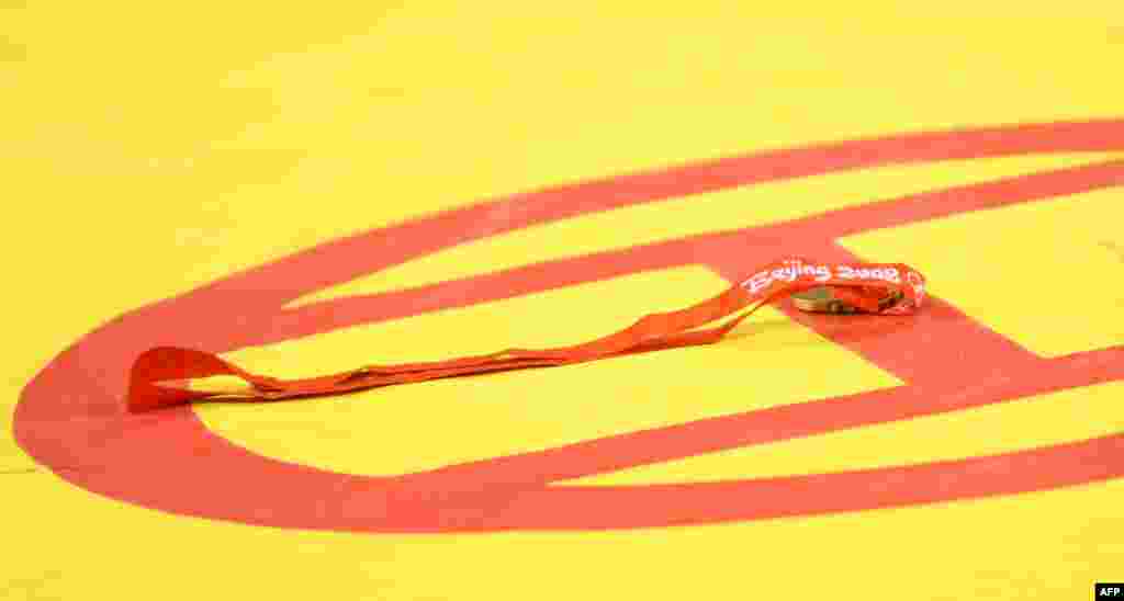 The disguarded bronze medal of Ara Abrahamian of Sweden rests on the mat after it was refused during the awards ceremony following the men's Greco-Roman 84-kg wrestling category during the 2008 Olympic Games in Beijing.