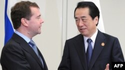 Russian President Dmitry Medvedev, left, shakes hands with Japanese Prime Minister Naoto Kan ahead of the Asia Pacific Economic Cooperation (APEC) Summit.