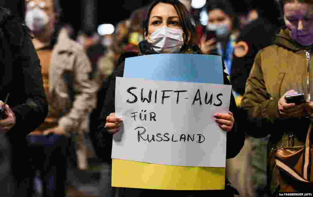 Demonstrators in Berlin demand that Russia be disconnected from the SWIFT financial system on February 25. A group of Western nations led by the United States, the European Union, and the United Kingdom have agreed to block access for "selected" Russian banks to SWIFT.