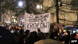 Poles protested the Kaczynskis' burial at Wawel Castle demonstrate in Krakow on April 13, holding a banner that asks, "Is he worthy of a king's burial?"