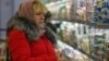 Покупательница в отделе молочной продукции симферопольского супермаркета. 