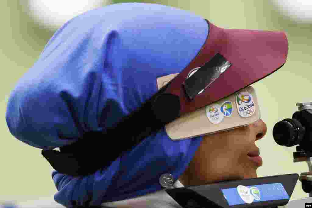 Elaheh Ahmadi of Iran takes aim during qualification for the women's 10-meter air rifle competition.