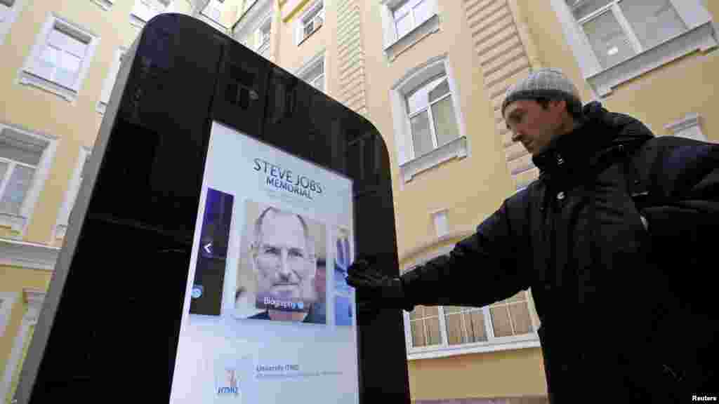 The screen displays video, photos and text documenting Jobs' life.